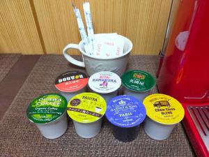 a group of coffee cups with toothbrushes in them at SECRET BASE Station Side in Osaka