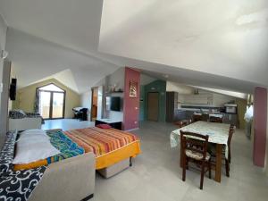 a large bedroom with a bed and a table in it at La dimora dei Sanniti in Busso