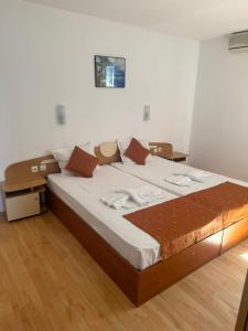 a bedroom with a large bed in a room at Sun City Hotel in Sunny Beach