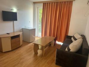 a living room with a couch and a table at Sun City Hotel in Sunny Beach