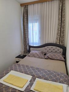 a bedroom with a bed with two towels on it at DRAGAm in Banja Luka