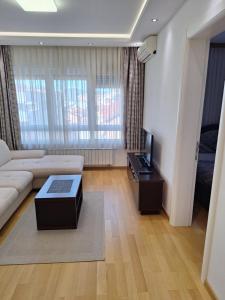 a living room with a couch and a tv at DRAGAm in Banja Luka