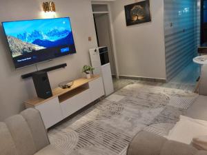 a living room with a flat screen tv on a wall at Weber Generations Accommodation -R & R Cozy Homes in Naivasha