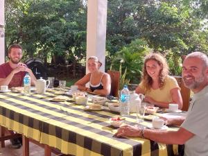 a group of people sitting around a table eating at Ridge Boundary View in Dambulla