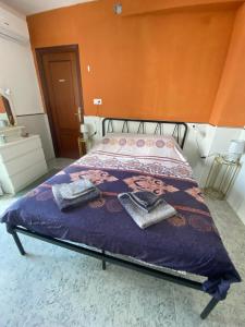 a bedroom with a bed with a purple comforter at The hidden Place in Alcaudete +31 photos