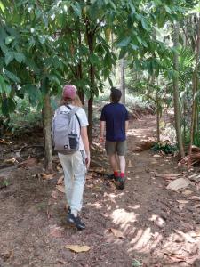 two people walking down a trail in the woods at Ridge Boundary View in Dambulla