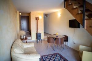 a living room with a white couch and a table at La Casetta In Piazza in Sulmona