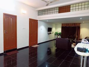 a living room with a couch and a table at Trendy stay service apartments 3bhk in Chennai