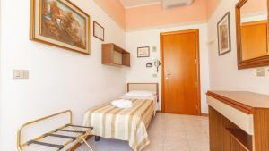 Postel nebo postele na pokoji v ubytování Hotel Parco Fellini