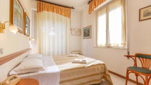 Postel nebo postele na pokoji v ubytování Hotel Parco Fellini