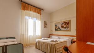 Postel nebo postele na pokoji v ubytování Hotel Parco Fellini
