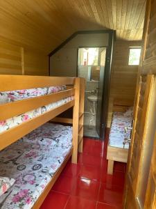 a room with two bunk beds in a cabin at Kamp Vodeni Ćiro in Setihovo