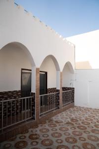 a room with arches and a tv on a wall at Blue Wave Home in Al Bustān