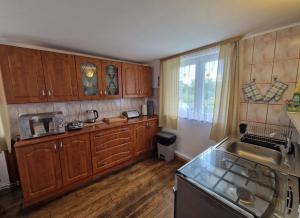 a kitchen with wooden cabinets and a sink at Ogrodowa 14 in Podgórzyn
