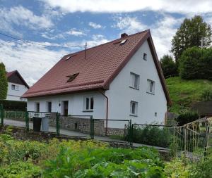 a white house with a brown roof at Ogrodowa 14 in Podgórzyn