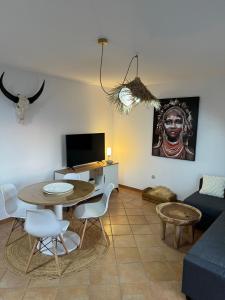 a living room with a table and a couch at Villa Miraki Fuerteventura Surf Relax in La Oliva