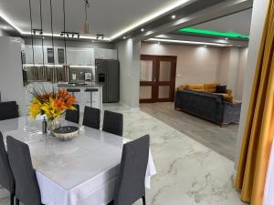 a kitchen and living room with a table and a couch at The Hillside Villa in Ognyanovo