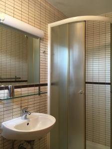 a bathroom with a sink and a shower at Apartments Jakišnica in Jakišnica +21 photos
