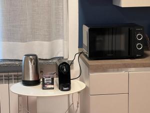 a microwave sitting on a counter next to a table at Appartamento Il glicine Cremona Centro in Cremona