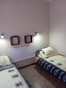 a room with two beds and two monitors on the wall at Stég Vendégház in Szigetszentmárton +13 photos