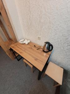 a wooden table with a tea kettle on top of it at Антарес Отель in Shemonaīkha