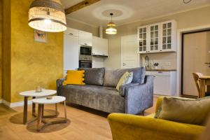 a living room with a couch and a table at Linnupesa Apartment in Viljandi