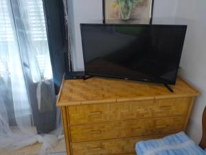 a flat screen tv sitting on a wooden dresser at Monolocali Tra Rieti e Terminillo e lago del Salto in Terminillo