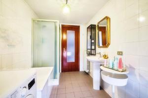 a bathroom with a tub and a sink and a bath tub at Art & Design In Centro Storico in Casalmaggiore +12 photos