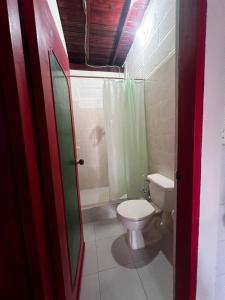 a bathroom with a toilet and a shower at Finca la frondosa - La frondosa farm in Angelópolis