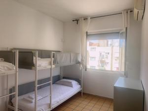 two bunk beds in a small room with a window at Lisa HOUSE in Rome