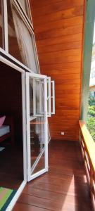 an open door in a room with a wooden floor at cinnamon avenue cabanas in Negombo