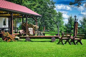 a park with benches and a gazebo at Zbójnicka Chata in Duszniki Zdrój