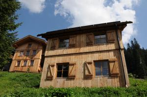 a wooden house on top of a hill at Design Chalet Zirm - check-in at Olympia Hotel in Varda +5 photos