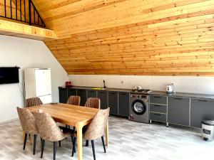 a dining room with a wooden table and chairs at Blue Pool Paradise in Gabala