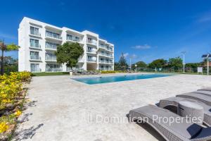 an apartment with a swimming pool in front of a building at Sosua private apartments and studios! in Laguna del Higüero
