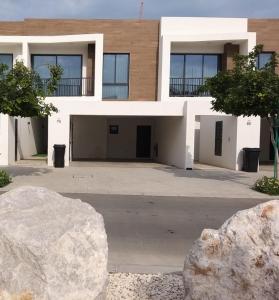 a building with a large rock in front of it at Relaxing villa with access to pool and beach in Ras al Khaimah