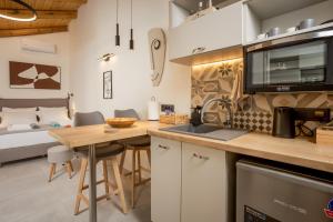 a kitchen with a table and a bed in a room at Comfinest in Chania