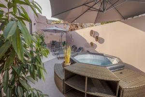 a table and chairs with an umbrella on a patio at Comfinest in Chania
