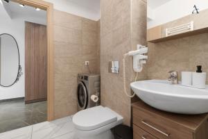 a bathroom with a sink and a toilet in it at Maia Apartment with One Bedroom & Fully kitchen in Bucharest +39 photos