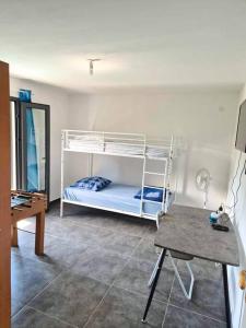a room with a bunk bed and a desk at O' Calme - Duplex - T3 - Piscine in Le Dioré