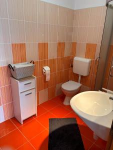 a bathroom with a toilet and a sink at Apartmani Knežević in Posedarje +13 photos