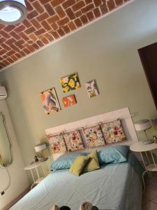a bed in a bedroom with pictures on the wall at A CASA DI NINNI "Orsola room" in Turin