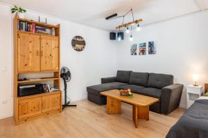 a living room with a couch and a table at Der Zwergenbau in Badenweiler