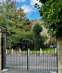 a wrought iron gate in front of a castle at Flower Cottage by Ludlow Castle with Onsite Parking in Ludlow