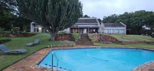 a house with a swimming pool in front of a house at Crest Farm Cottage in Waterfall