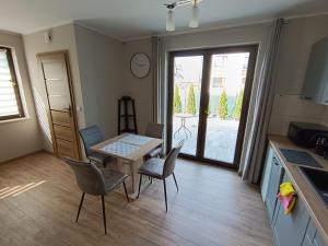 a kitchen and dining room with a table and chairs at Noclegi u Edyty in Zator