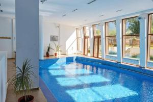 a large swimming pool with blue water in a house at Mountain Studio - Ski in and out - FREE Spa in Bansko