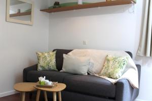 a living room with a couch and a table at Le Petit Saint Trophime in Saint-Rémy-de-Provence