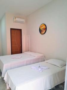 two beds sitting next to each other in a room at Pousada Flor da Barra in Maragogi +44 photos