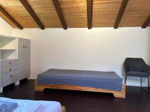 ein Schlafzimmer mit einem Bett und einem Stuhl in der Unterkunft Ferienwohnung #3 Harzblick mit Sauna in Oberwössen
